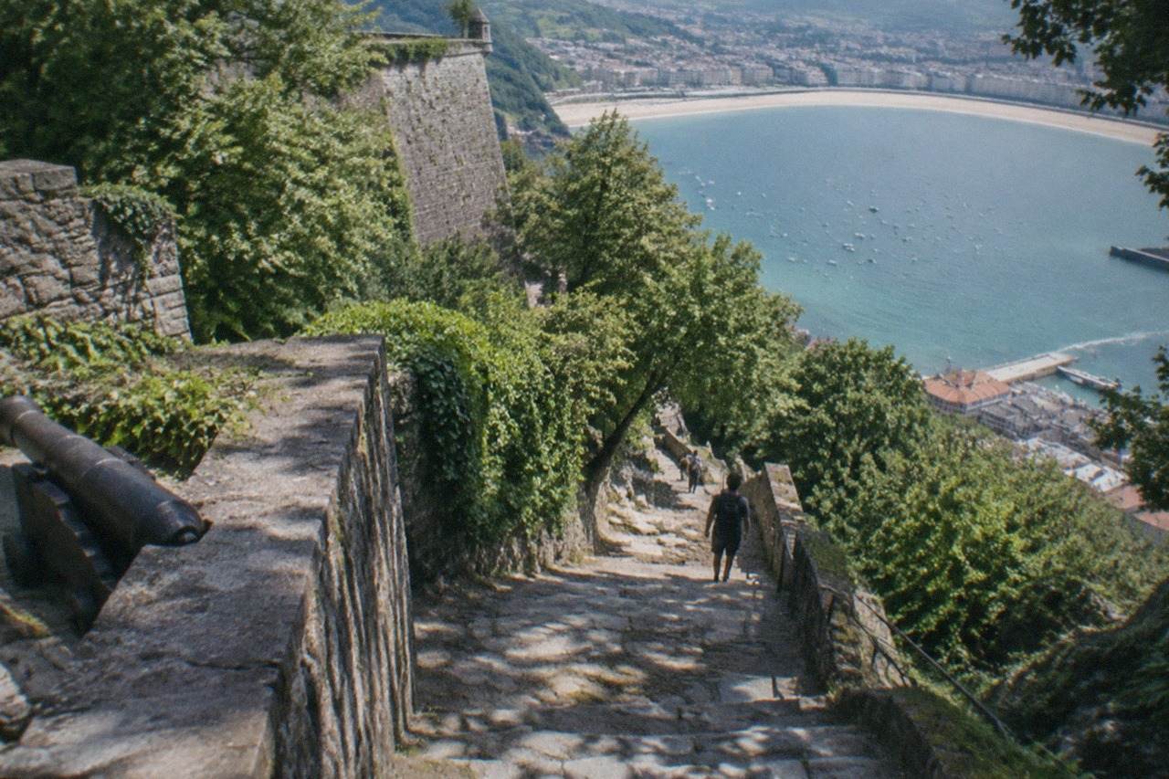 Wooded slopes of Mount Urgull rising above the buildings and bay of San Sebastián