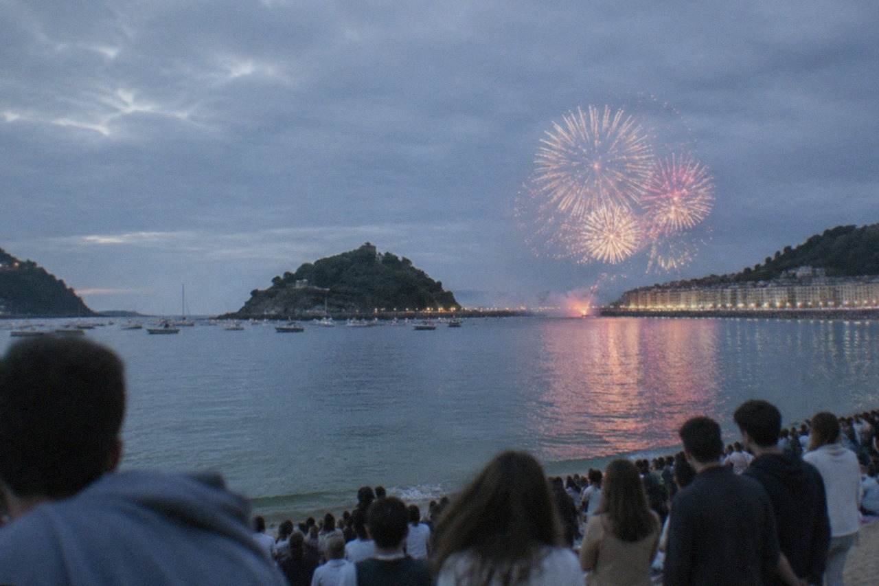 Crowds watching fireworks over La Concha bay in San Sebastián during Semana Grande