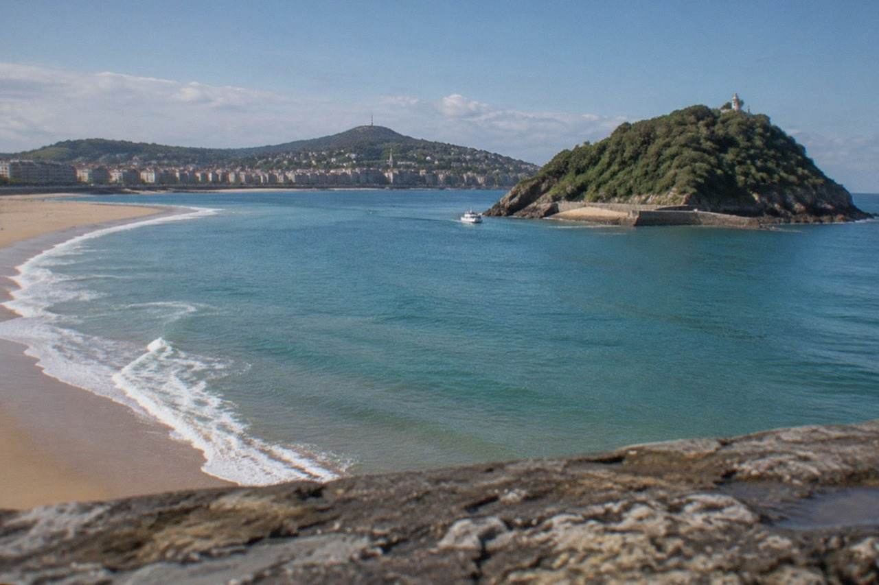 The sandy curve of La Concha beach in San Sebastián with Santa Clara island in the bay