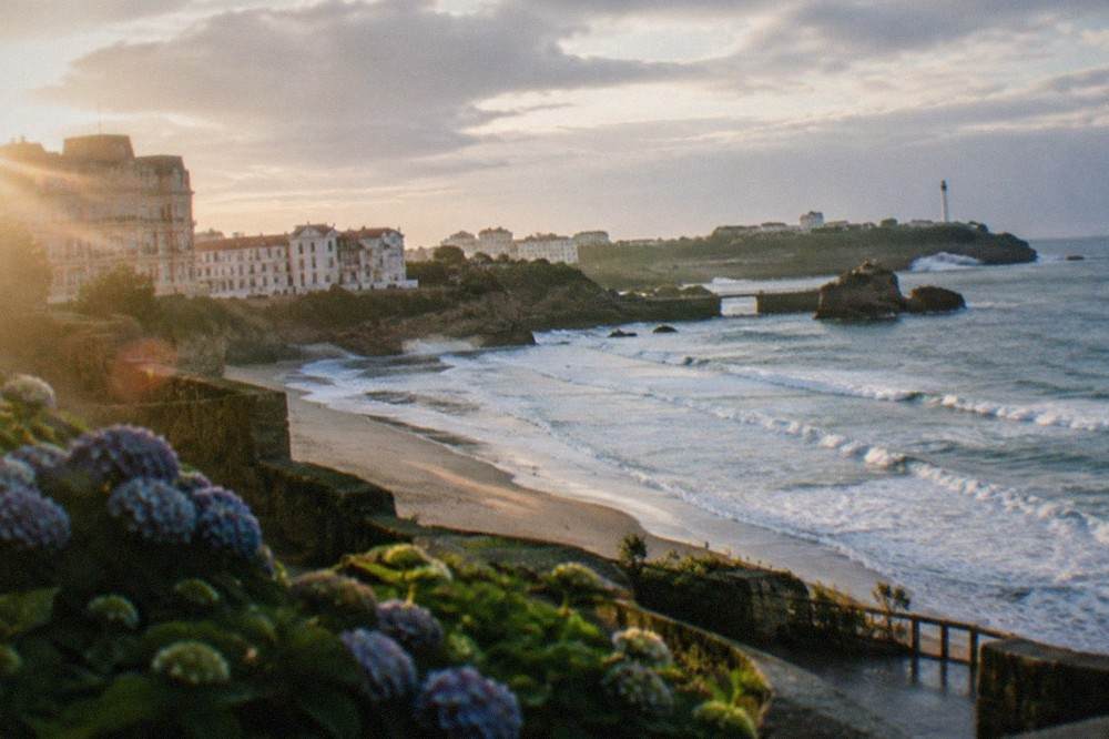 White buildings above a beach with surf breaking on the French Atlantic coast at Biarritz