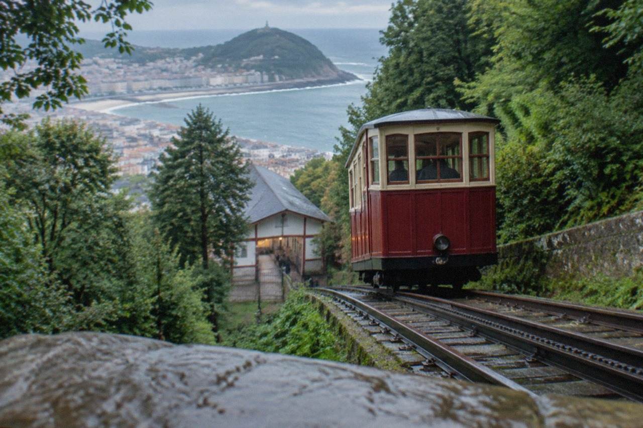 The wooden funicular car climbing the wooded slope of Monte Igueldo above the houses of San Sebastián