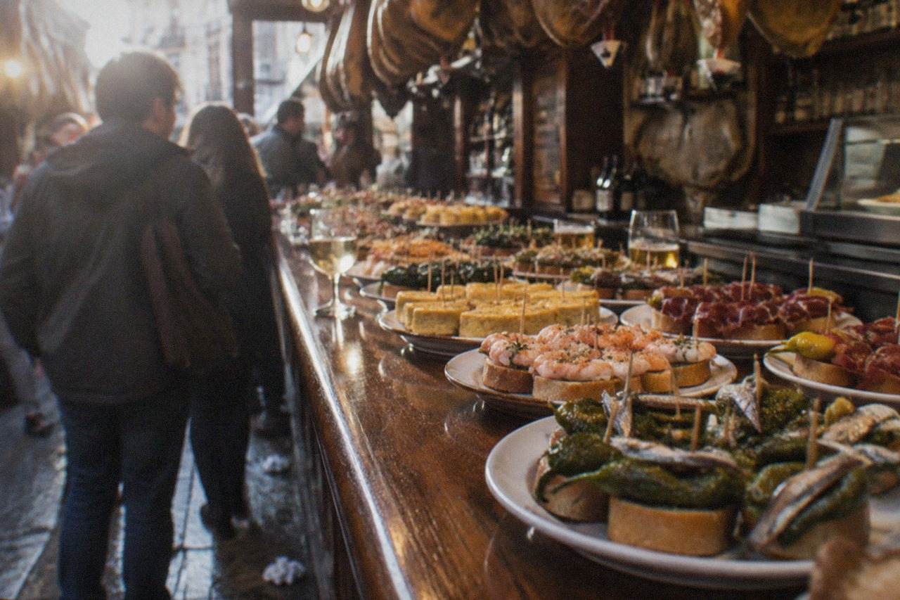 Pintxo bars with counters of small skewered snacks in an old town street in San Sebastián