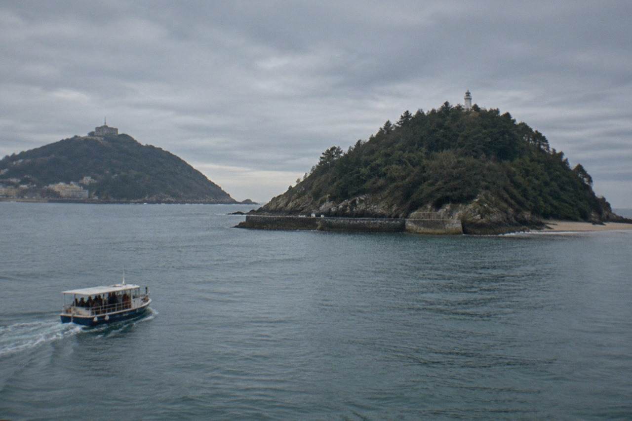 Evening view across La Concha bay in San Sebastián with Santa Clara island and Monte Igueldo in the distance