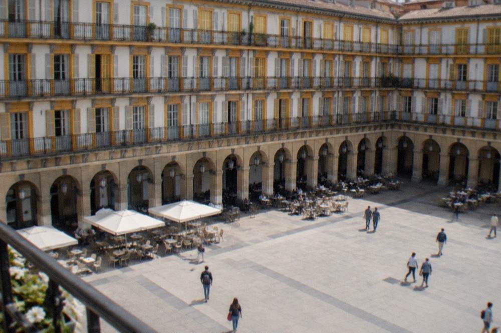 Plaza de la Constitución in the Parte Vieja with numbered balconies and café tables