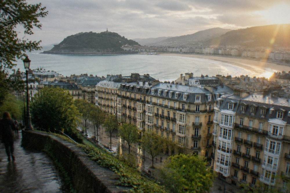 Evening light over the rooftops and bay of San Sebastián seen from a hillside path