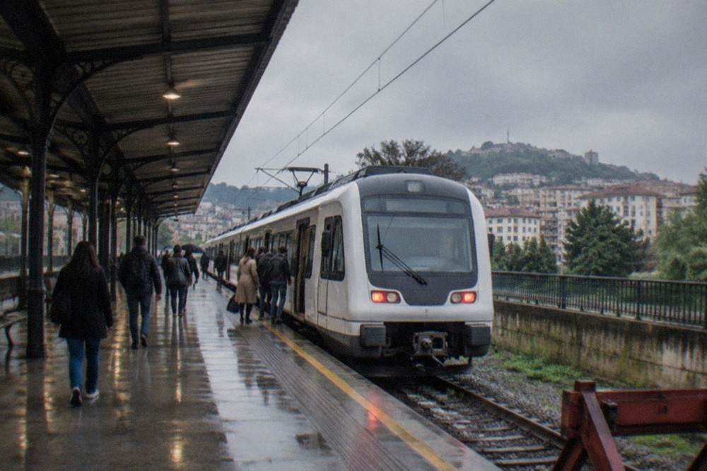 The Euskotren Amara station platform with a white train waiting under a covered roof