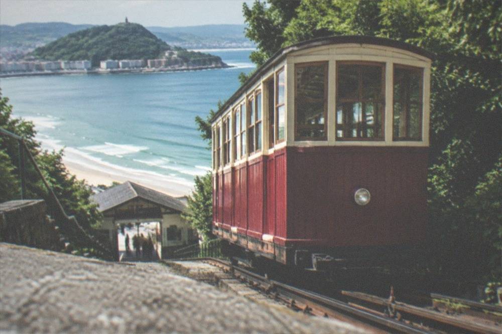 Wooden funicular car at the Monte Igueldo base station beside the beach
