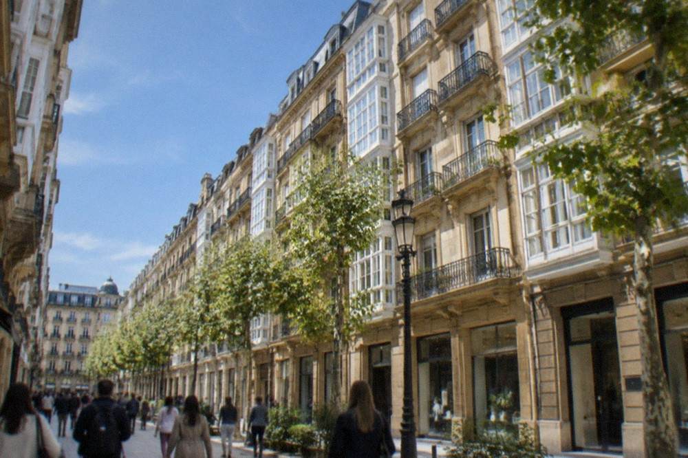 A busy shopping street in the Centro district of San Sebastián on a bright afternoon