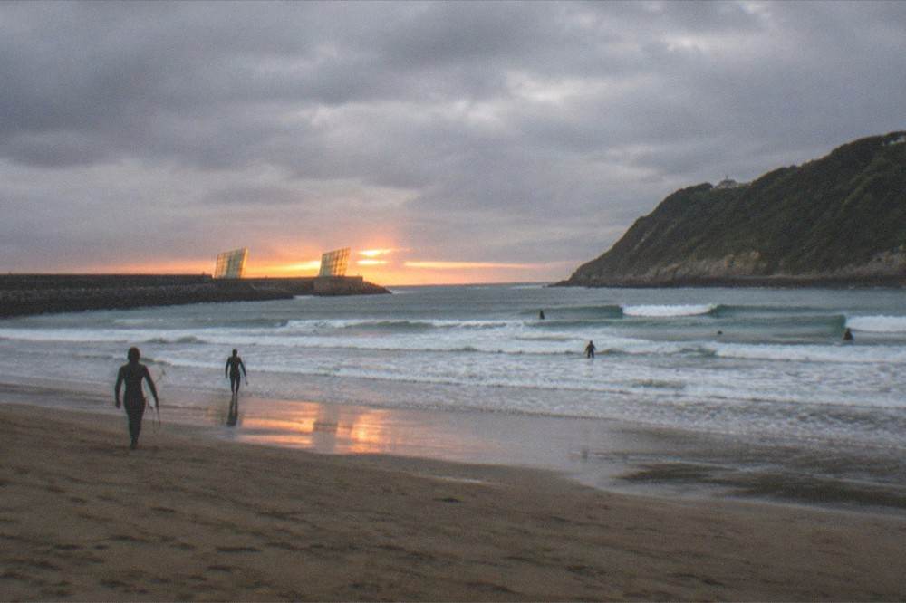 Sunset light on the Kursaal cubes and the Zurriola river mouth seen from the Gros side