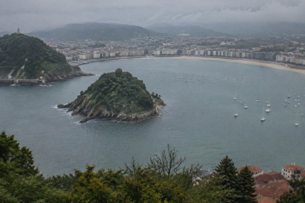The curved bay of La Concha in San Sebastián seen from above with the city neighbourhoods spread along the shoreline
