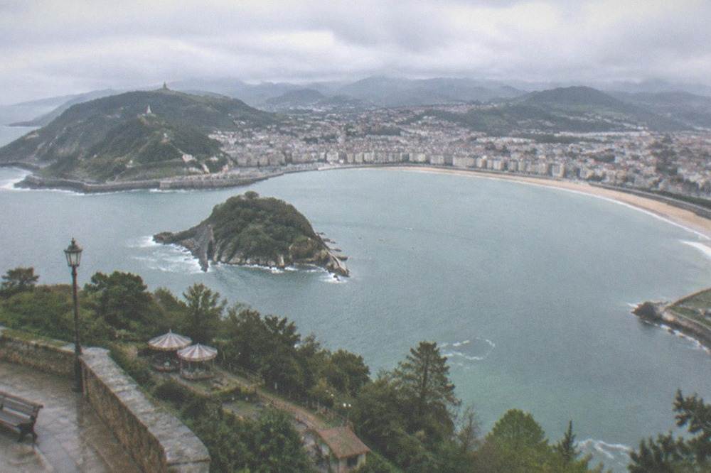 Ondarreta beach and the Antiguo district with Monte Igueldo rising behind the west end of the bay
