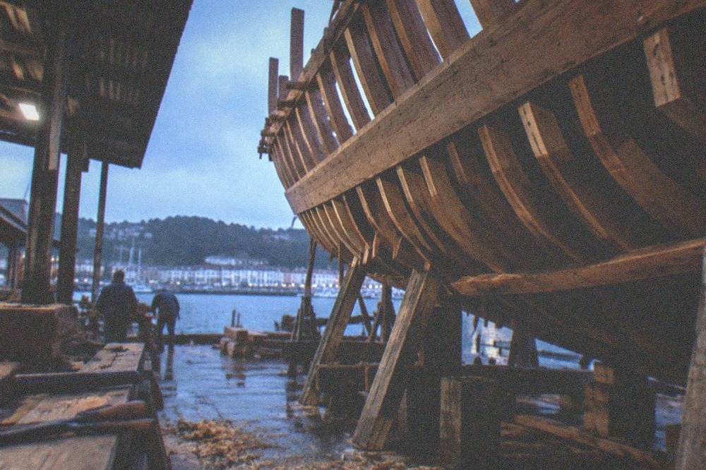 Exhibition panels and model ships explaining Basque whaling history in a museum hall