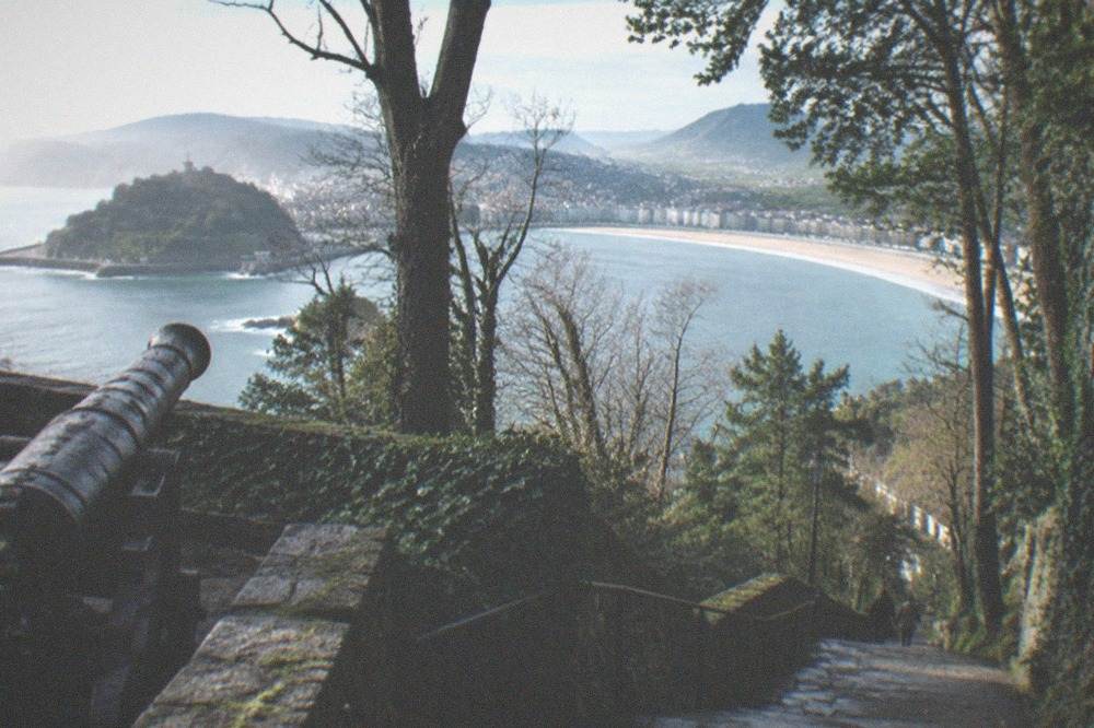 View over La Concha bay from the wooded slopes of Monte Urgull above the Old Town