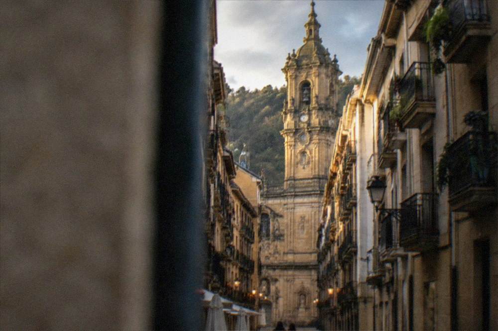 Evening light on the old streets of the Parte Vieja in San Sebastián with the basilica tower above