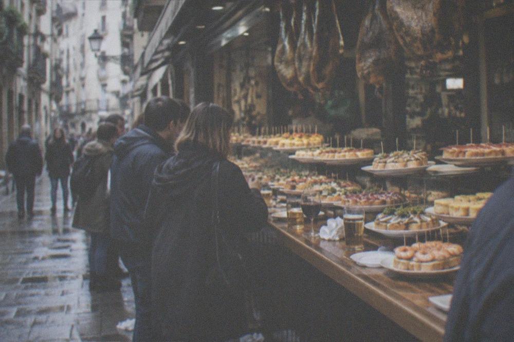 Pintxo bars and standing customers in a narrow Old Town street a short walk from the cathedral.