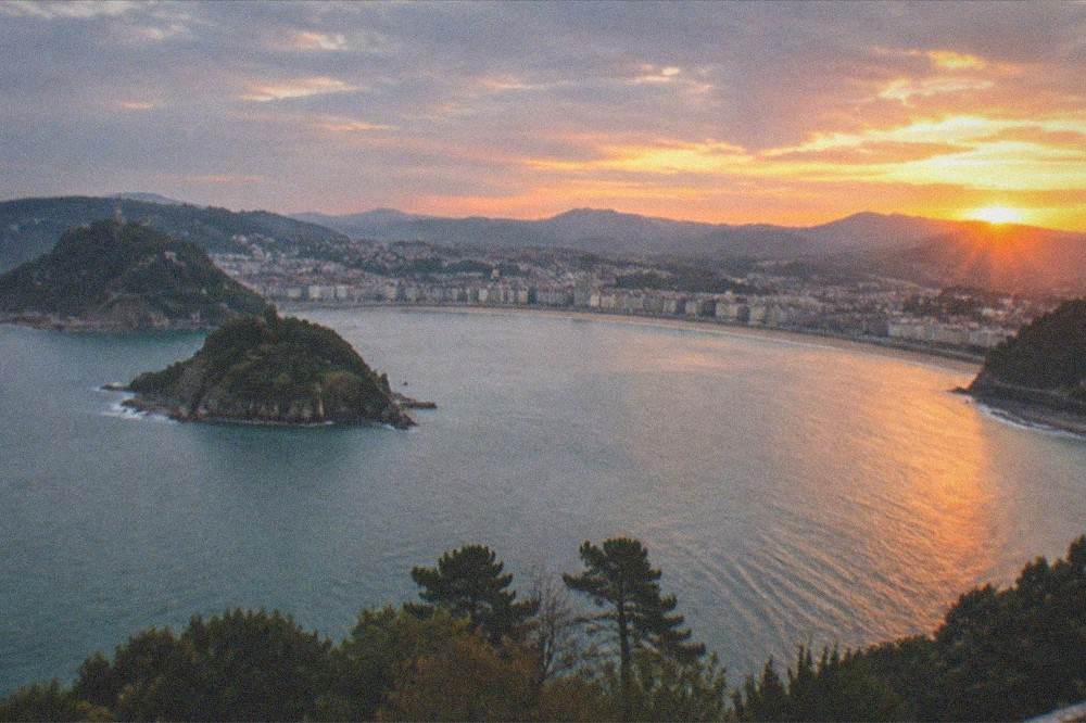 Sunset over La Concha bay seen from a hilltop above the city