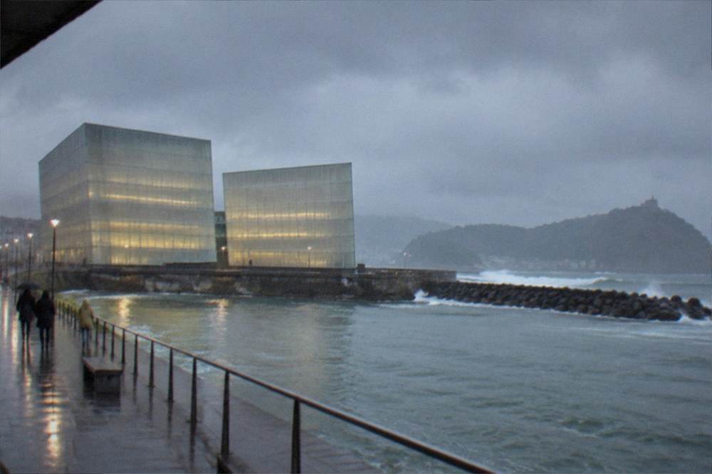 Rain clouds over the bay behind the Kursaal cubes with the seafront promenade below