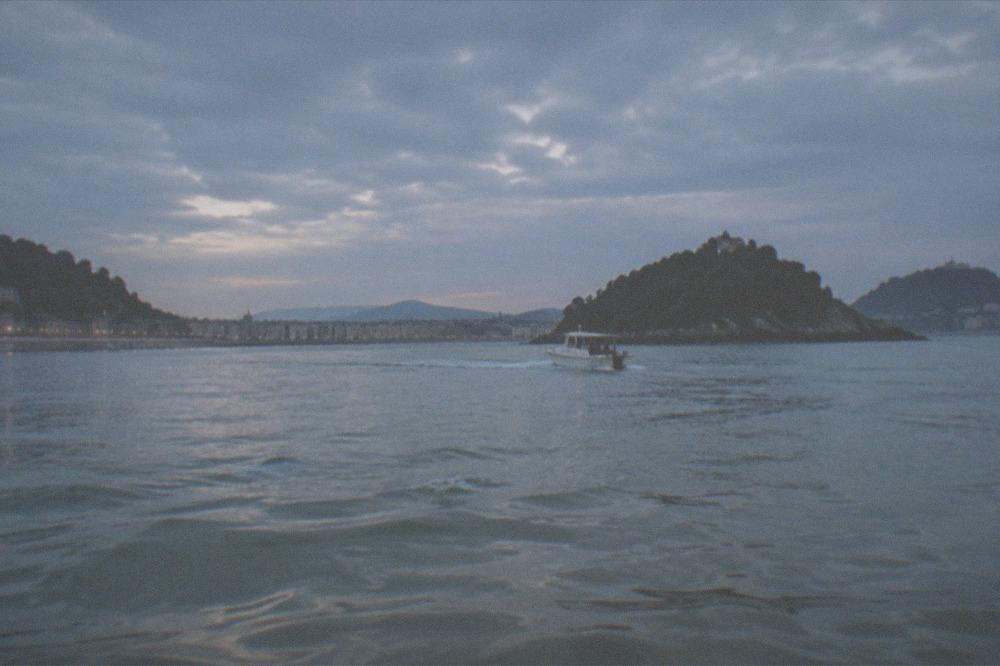 A small boat crossing La Concha bay towards Santa Clara island