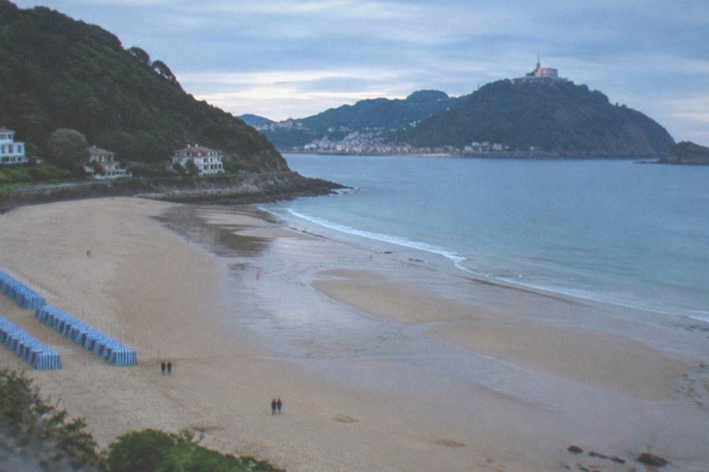 Ondarreta beach at low tide with Monte Igeldo in the background