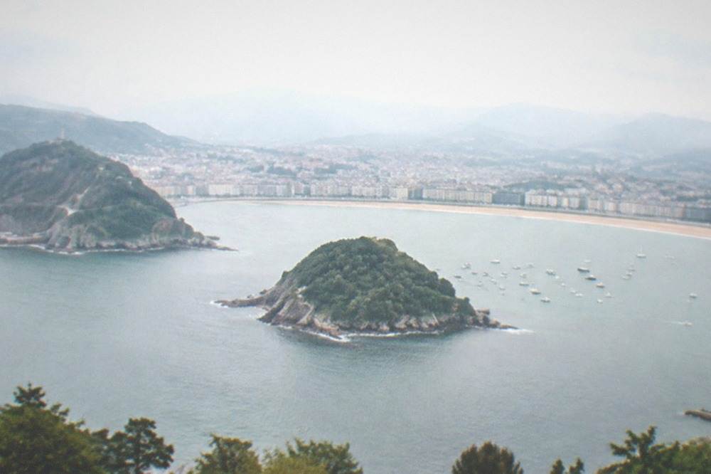 Panorama of La Concha bay seen from high ground with the island in the middle