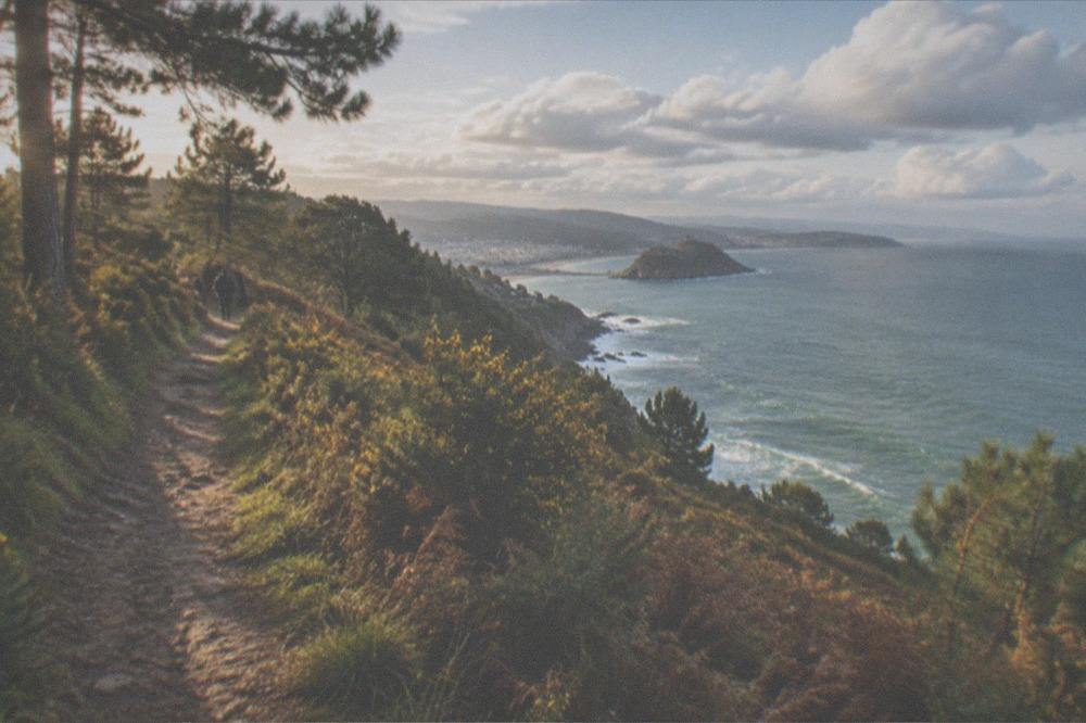 Coastal path on a bright day with cumulus clouds over the Bay of Biscay