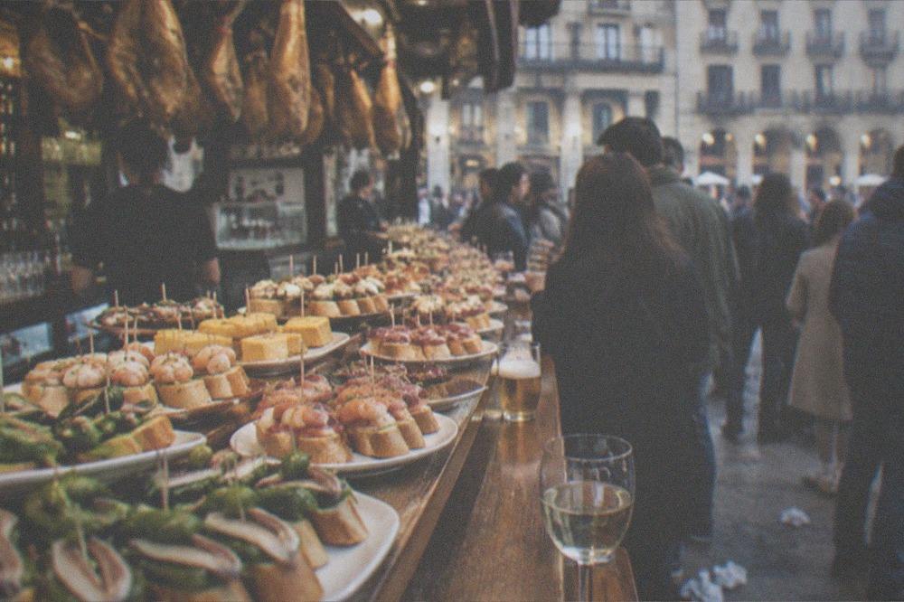Pintxo bars and crowded evening street near the Plaza de la Constitucion in San Sebastián