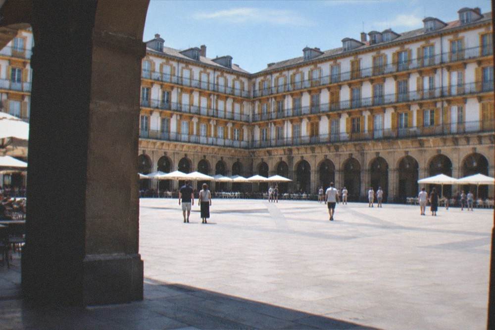 Wide view of the Plaza de la Constitucion with its arcades and facades in San Sebastián