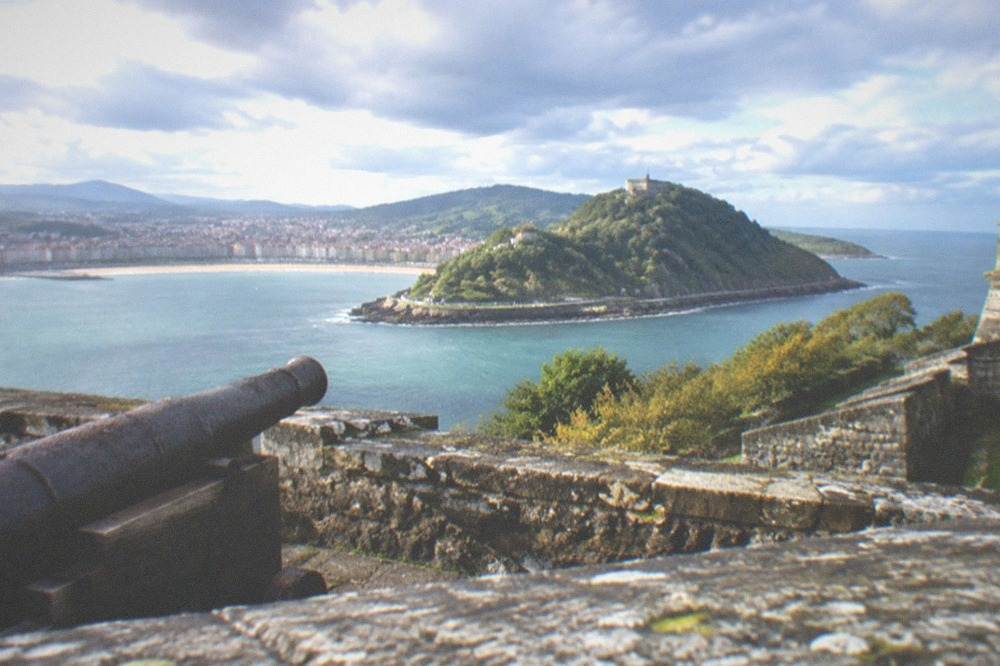 View across the harbour to the green slopes of Monte Urgull and the Castillo de la Mota