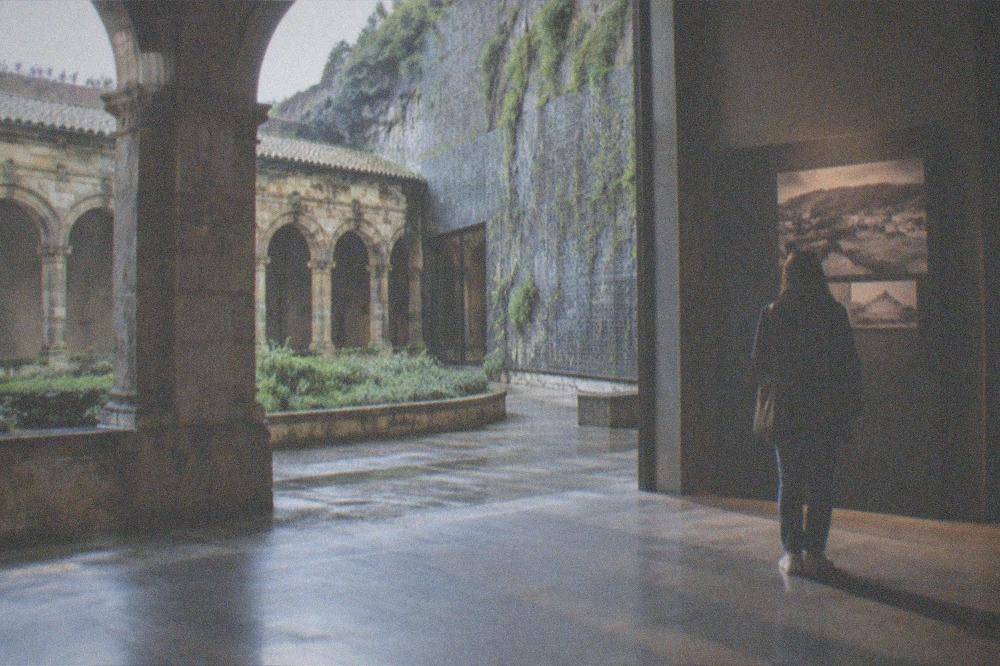 A visitor reading a display panel in a quiet gallery of the San Telmo Museoa