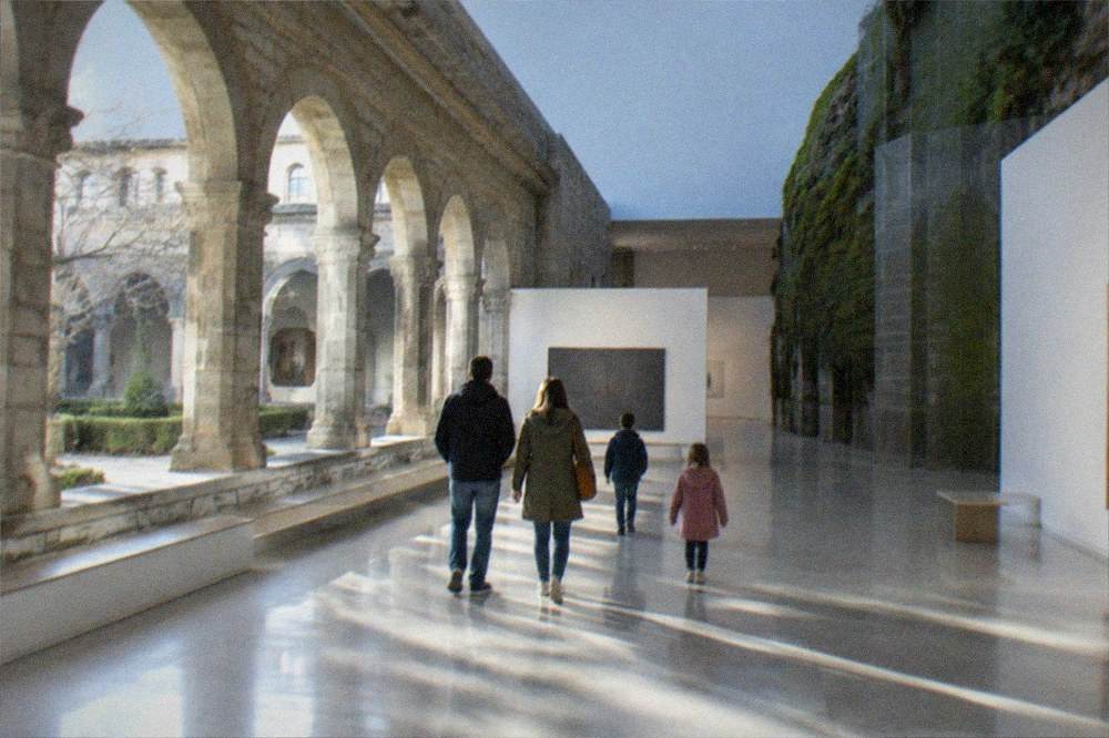 A family walking through a bright gallery of the San Telmo Museoa