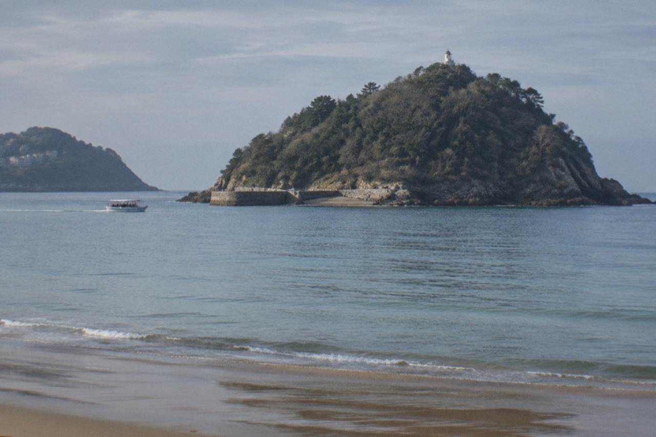 Santa Clara Island seen from La Concha beach in San Sebastián with the bay calm around it