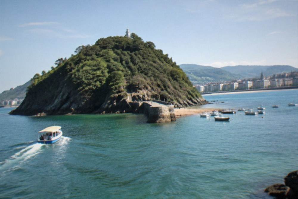 The island landing point with small boats moored and the city behind