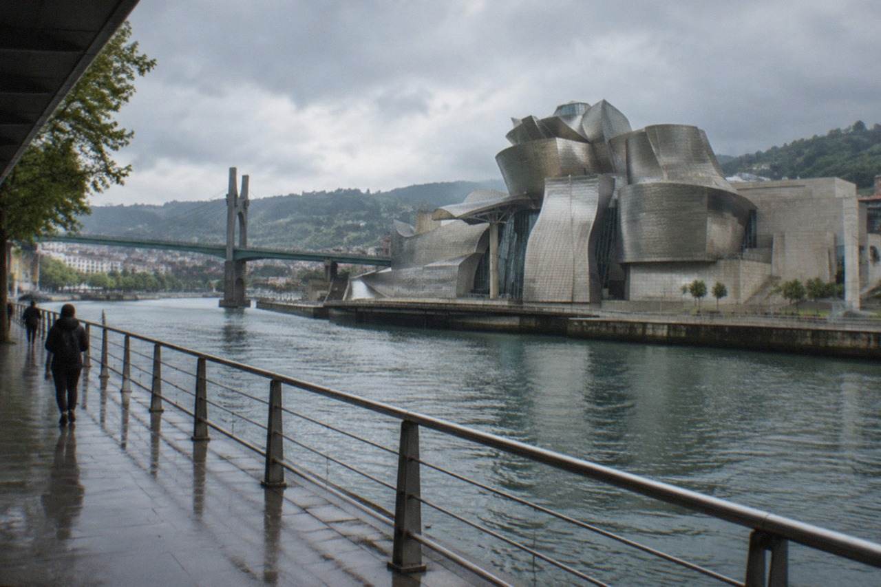 The Guggenheim Museum Bilbao beside the Nervion river on a bright morning