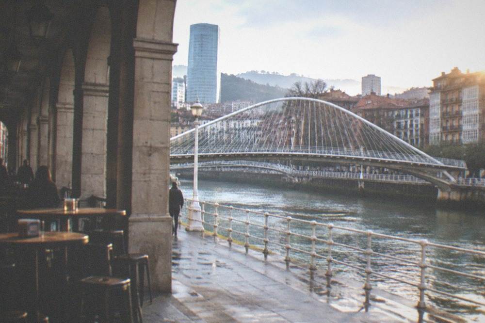 The Zubizuri footbridge over the Nervion river with the city behind it