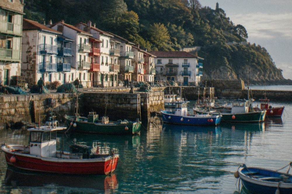Fishing boats moored in the small harbour of a Basque coastal town