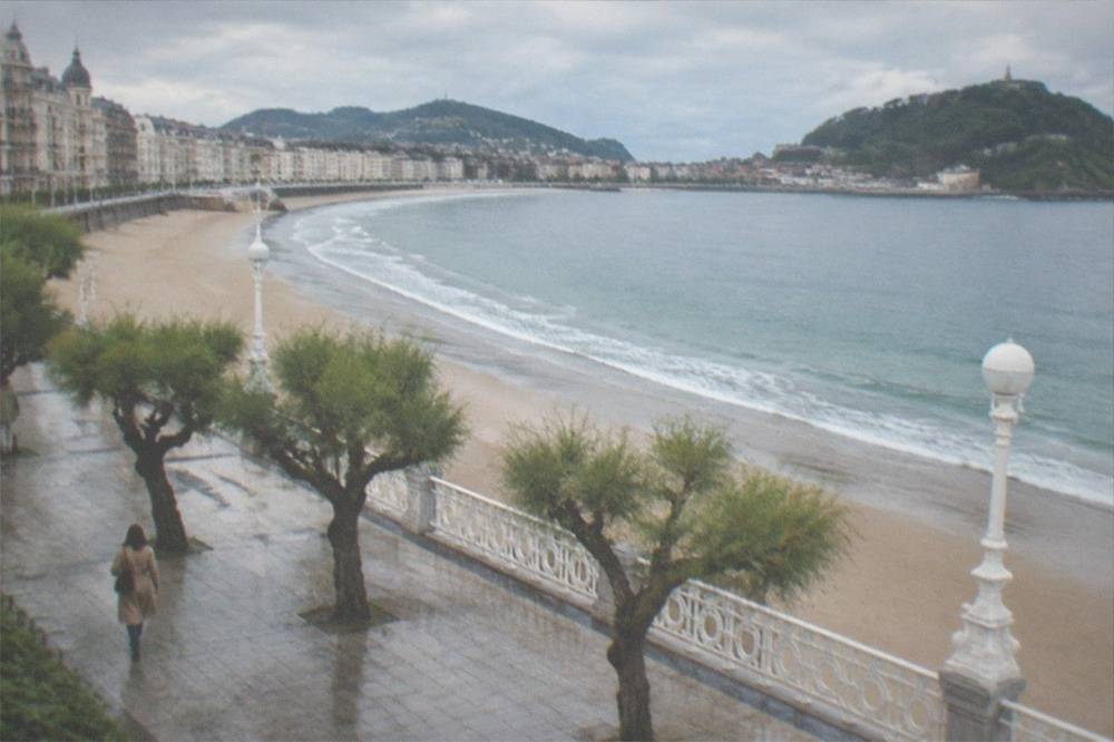 A grand seaside promenade with ornate historic buildings facing the ocean