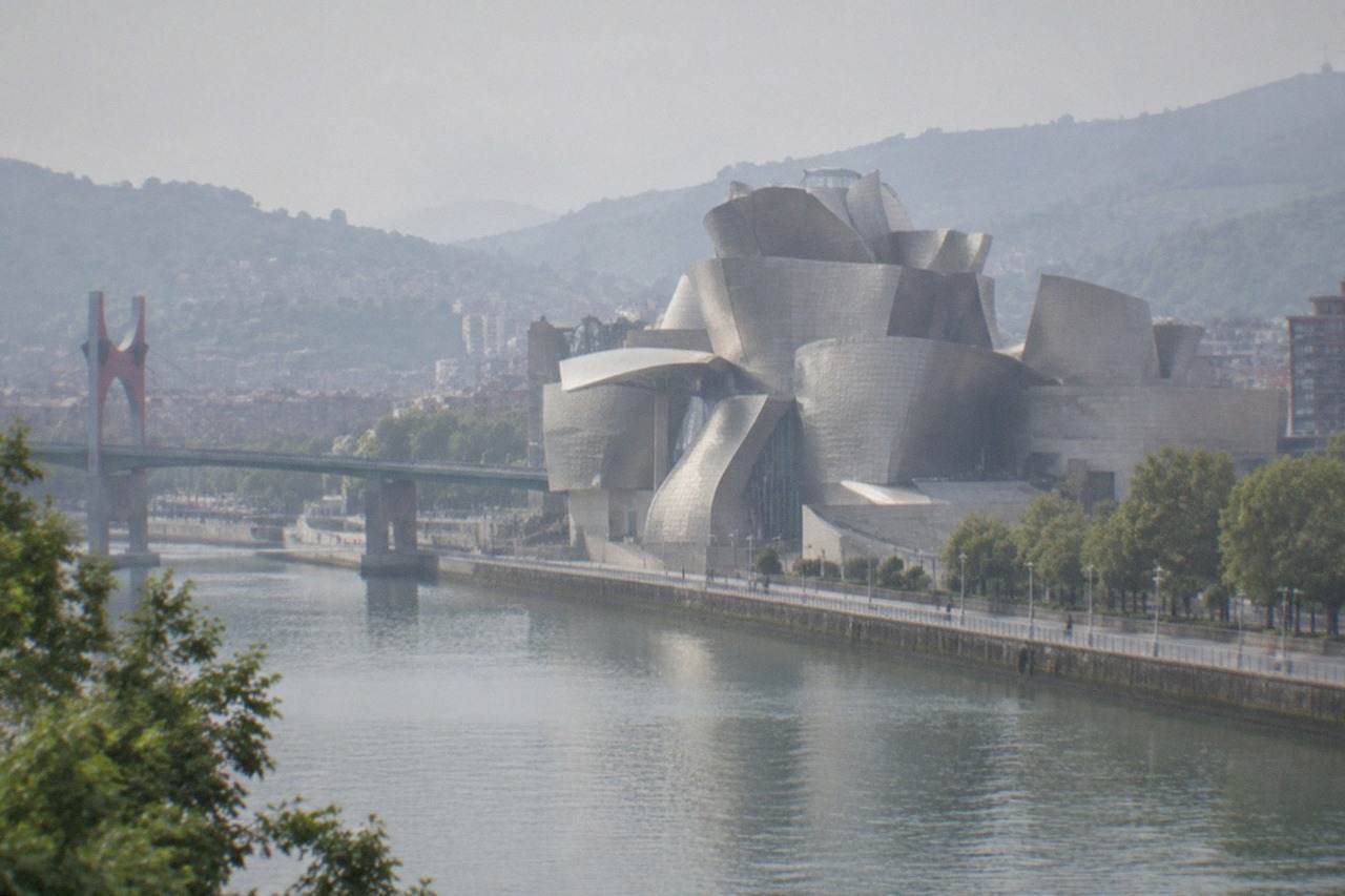 The titanium curves of the Guggenheim Museum rising beside the river in Bilbao on a bright morning
