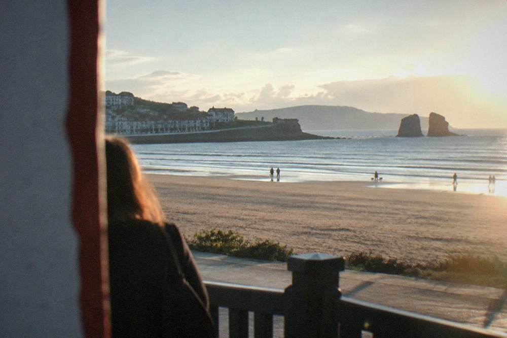The wide sandy shore at Hendaye with gentle waves and a promenade