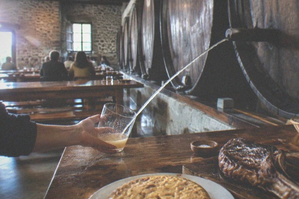 A cider house dining room with barrels and long wooden tables