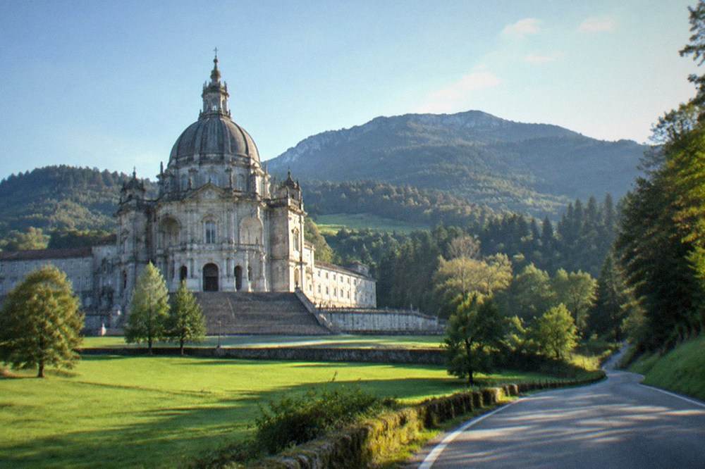 A quiet road winding through green hills and woods in inland Gipuzkoa in the Basque Country