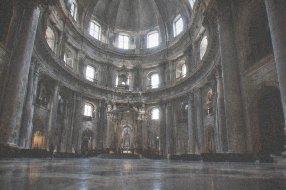 The domed interior of the basilica at Loyola, with columns and a high central dome above the circular nave