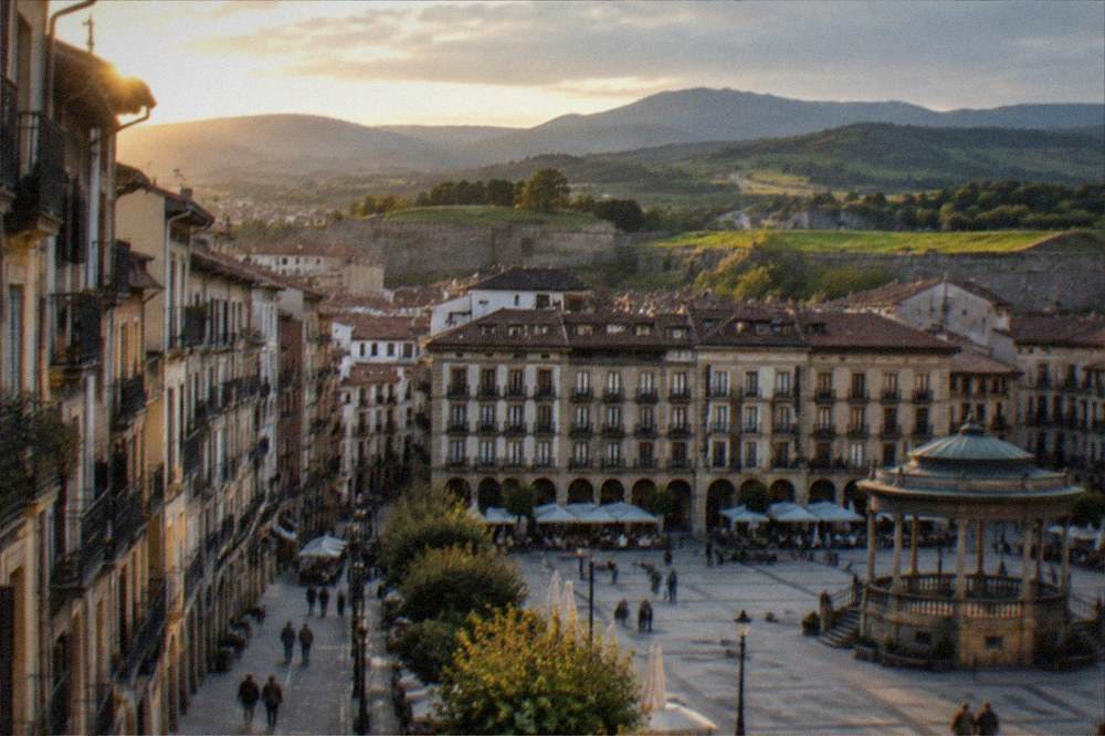 Rolling green hills of Navarre with a road winding toward distant mountains