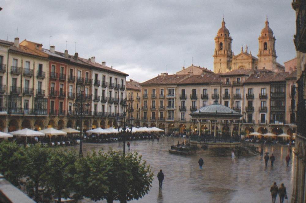 The towers of Pamplona's cathedral rising above the old town rooftops at golden hour