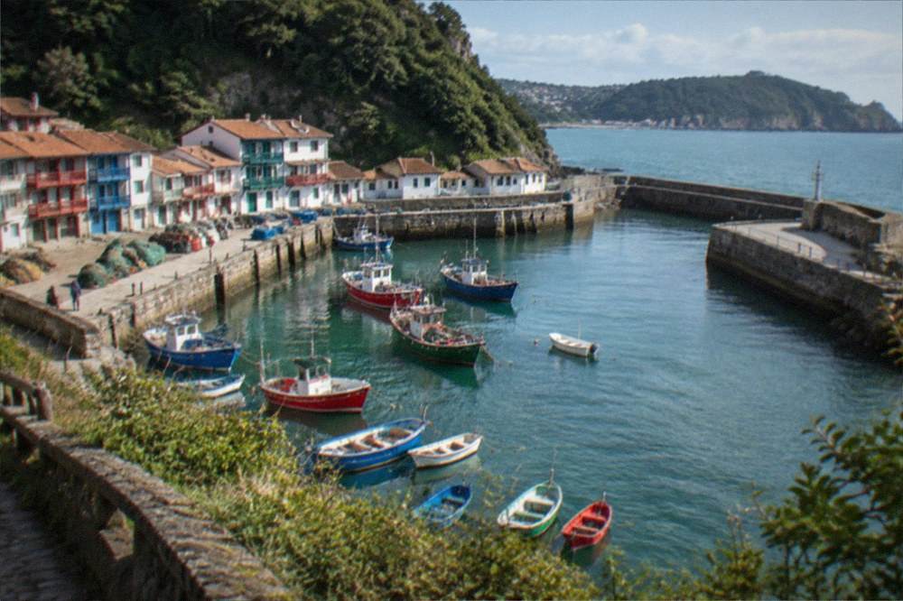 View from a clifftop path down to the harbour mouth and the sea beyond Pasaia