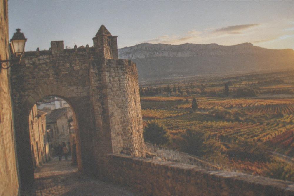 Stone gate and walls of Laguardia old town at golden hour