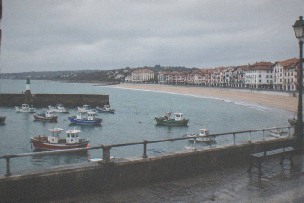 The south-facing town beach of Saint-Jean-de-Luz curving inside its bay with the promenade in front