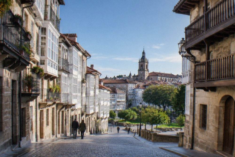 Cobbled medieval street in Vitoria-Gasteiz with stone buildings and wooden balconies