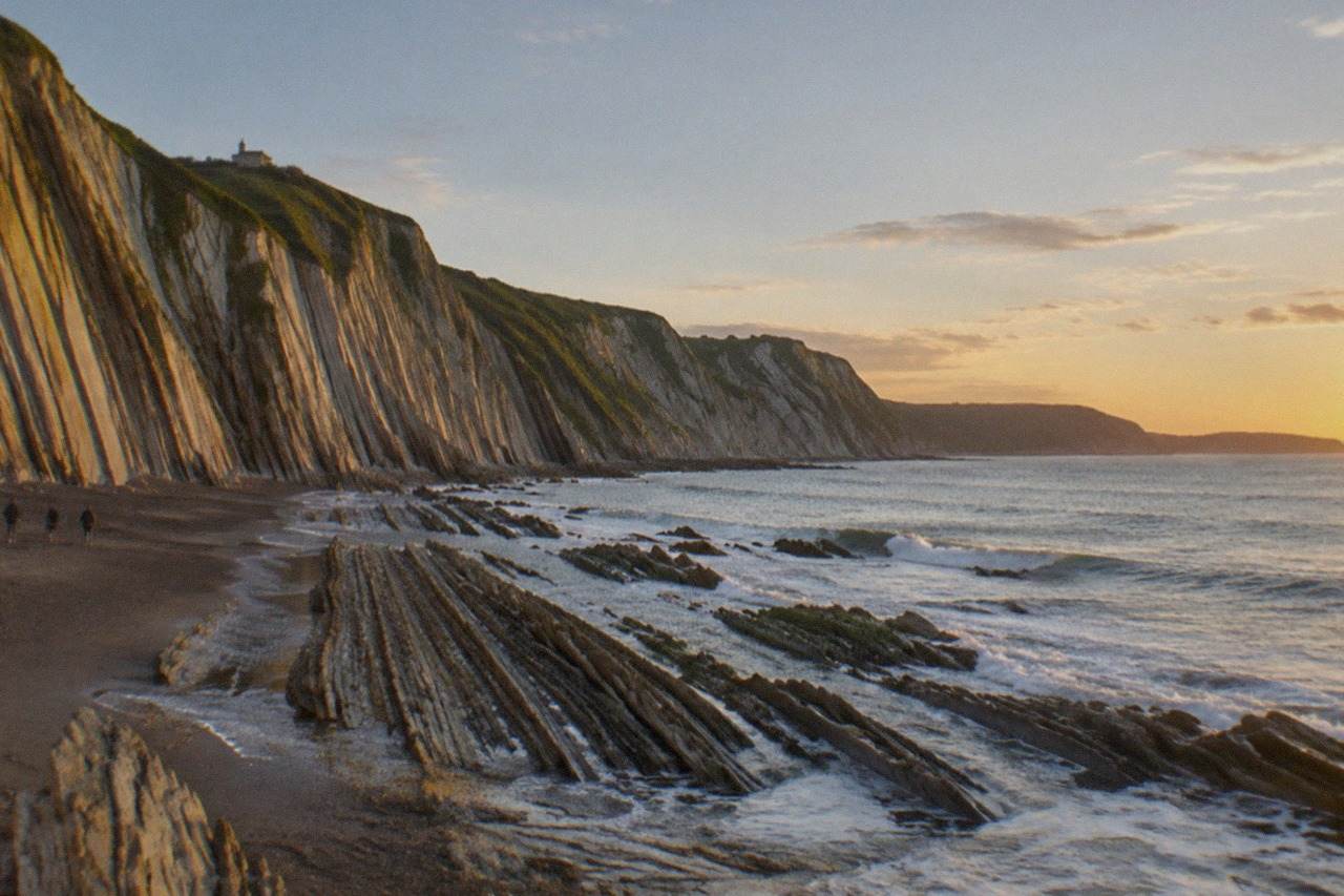 Tall layered cliffs dropping into the sea at Zumaia on the Basque coast