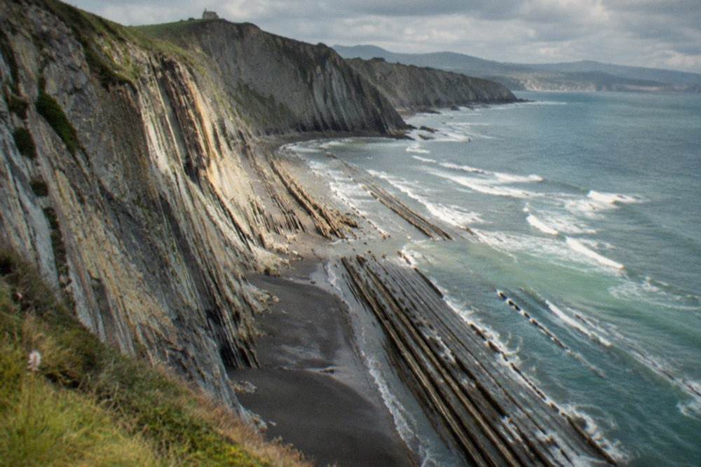 Close view of thin tilted rock strata in the cliff face at Zumaia