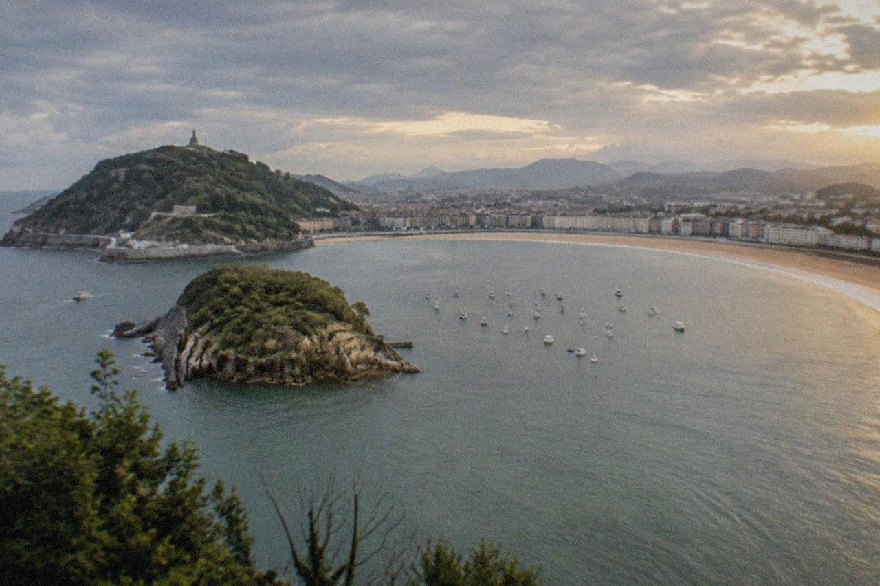 La Concha bay in San Sebastián seen from above, with the beach curving between two hills